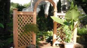 A very elegant curved wood arbor makes the entrance to this customers garden very inviting.