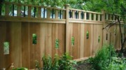 Custom Qual Line designed privacy fence with cut outs and vertical black pipe topper