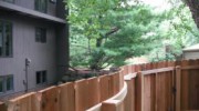 This customer wanted her fence to meander through her yard. Instead of taking the easy way like other contractors we custom bent wood to form the horizontal backing rails.